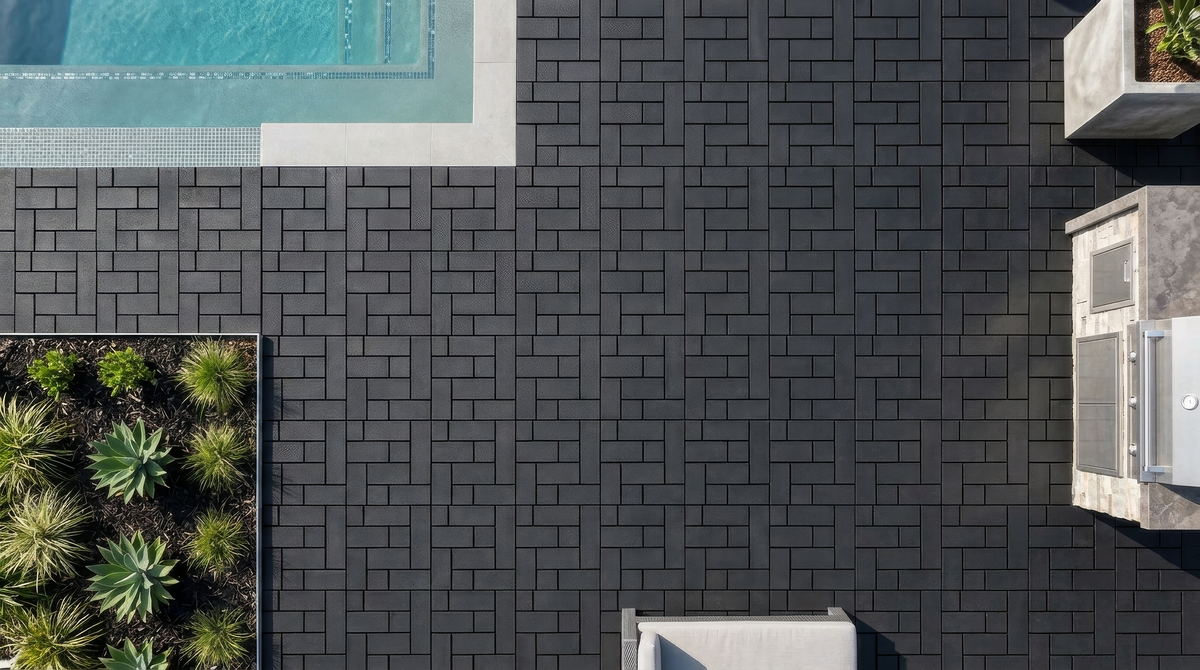Dark composite deck tiles beside a pool