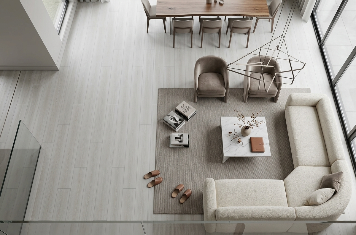 Cornsilk SPC vinyl flooring, shown in a living and dining area with a white sectional sofa.