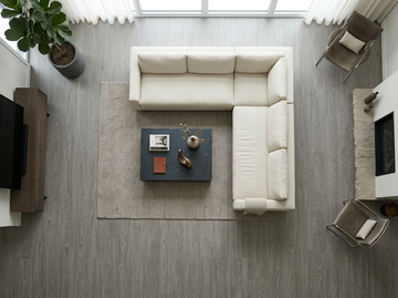 Everest SPC vinyl flooring, overhead view of a living room with a white sectional sofa.