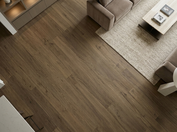 Milk Chocolate SPC vinyl flooring, close view beside a seating area and rug.